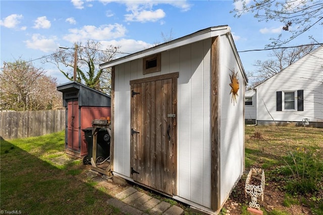 view of shed featuring fence