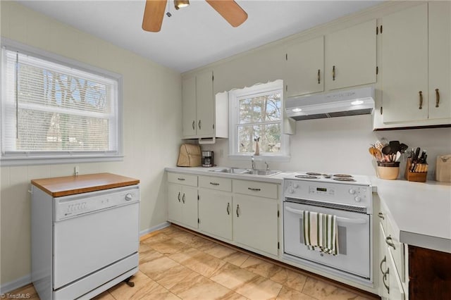 kitchen with white appliances, light countertops, a ceiling fan, under cabinet range hood, and a sink