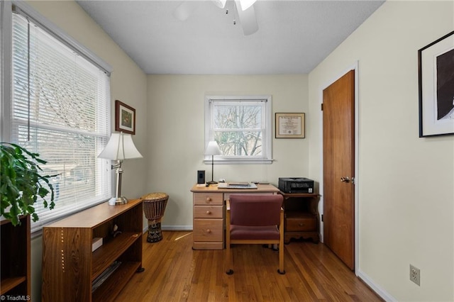 office area with ceiling fan, wood finished floors, and baseboards