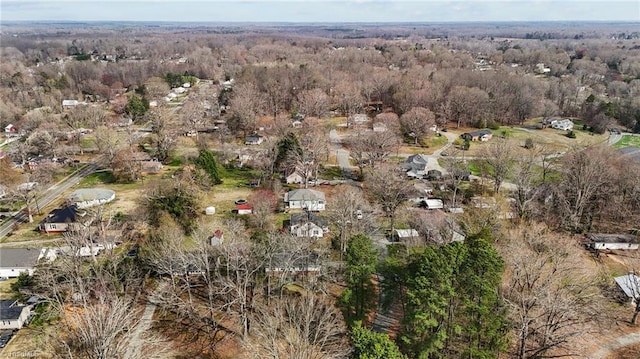 birds eye view of property with a view of trees