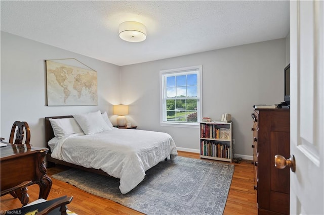216 E Devon Dr, Mount Airy, NC 27030 - bedroom featuring wood finished floors and a textured ceiling