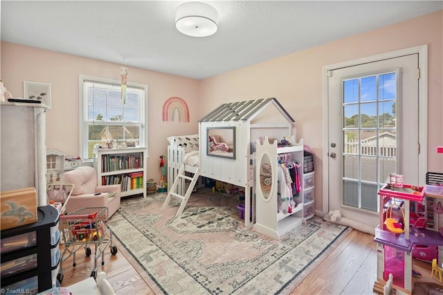 216 E Devon Dr, Mount Airy, NC 27030 - bedroom featuring multiple windows, access to outside, and wood finished floors