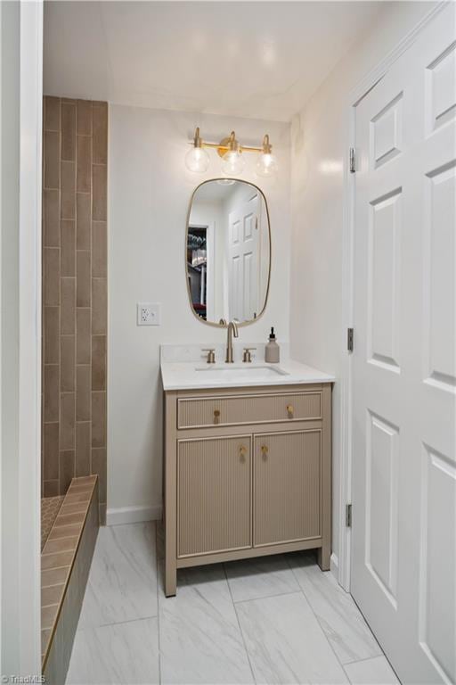 216 E Devon Dr, Mount Airy, NC 27030 - bathroom featuring marble finish flooring, vanity, and tiled shower