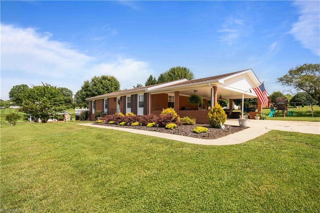 216 E Devon Dr, Mount Airy, NC 27030 - view of front facade with concrete driveway, a front lawn, an attached carport, and brick siding