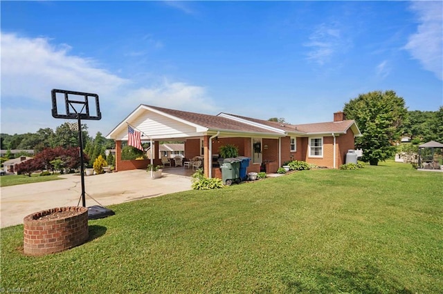 216 E Devon Dr, Mount Airy, NC 27030 - rear view of house featuring driveway, a lawn, a chimney, a carport, and brick siding