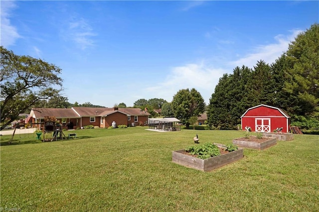 216 E Devon Dr, Mount Airy, NC 27030 - view of grassy yard with a garden and a storage shed