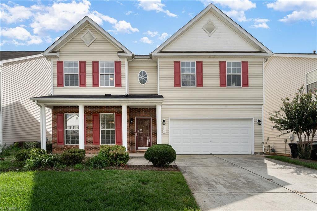 view of front of home with a front lawn and a garage