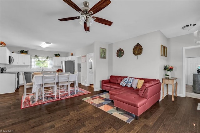 living room with ceiling fan, sink, and dark hardwood / wood-style flooring