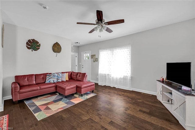 living room with ceiling fan and dark hardwood / wood-style flooring