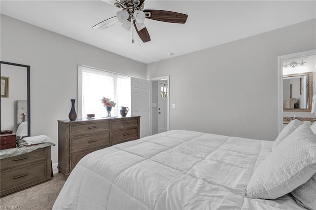 carpeted bedroom featuring connected bathroom and ceiling fan