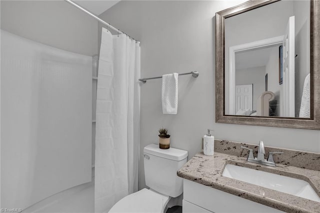 bathroom featuring walk in shower, vanity, and toilet