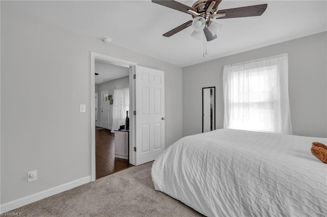 bedroom featuring dark carpet and ceiling fan