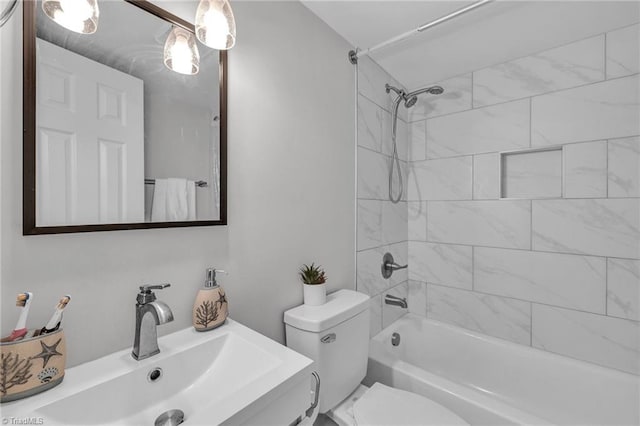 full bathroom with tiled shower / bath combo, vanity, and toilet