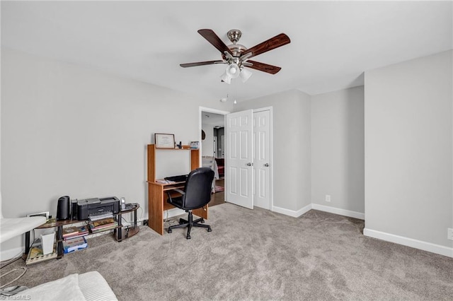 carpeted office space with ceiling fan