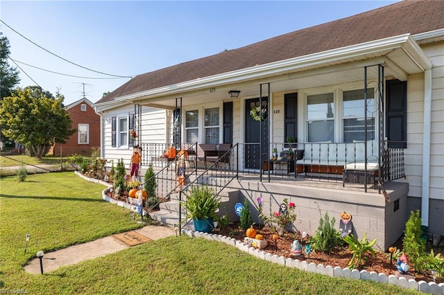 single story home with a porch and a front lawn