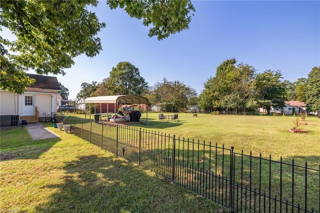 view of yard featuring cooling unit and a carport