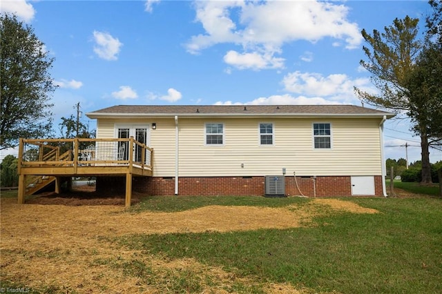 rear view of house featuring a yard, a wooden deck, and central AC unit