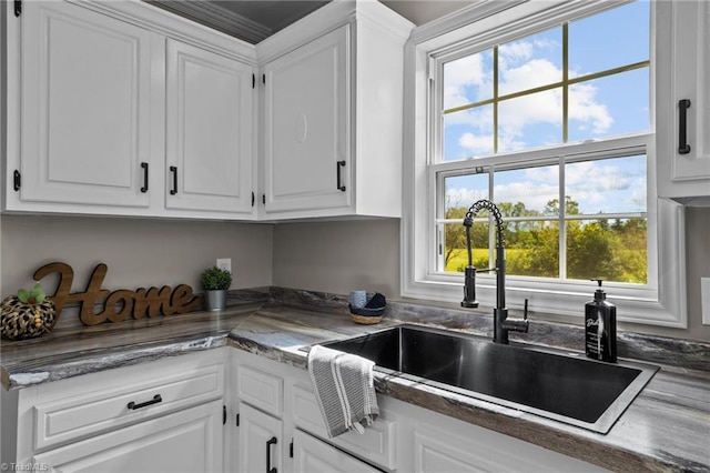 kitchen featuring sink, white cabinetry, and a healthy amount of sunlight