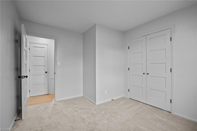 2505 Banner Whitehead Rd, Sophia, NC 27350 - unfurnished bedroom featuring a closet, carpet flooring, and baseboards
