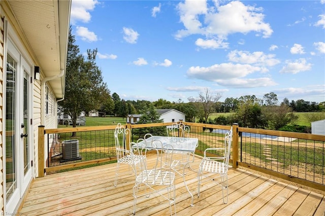 wooden terrace with central air condition unit and a lawn