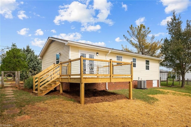 back of house with a yard, a deck, and central AC