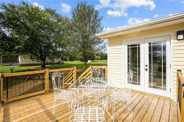 wooden terrace with french doors and a yard