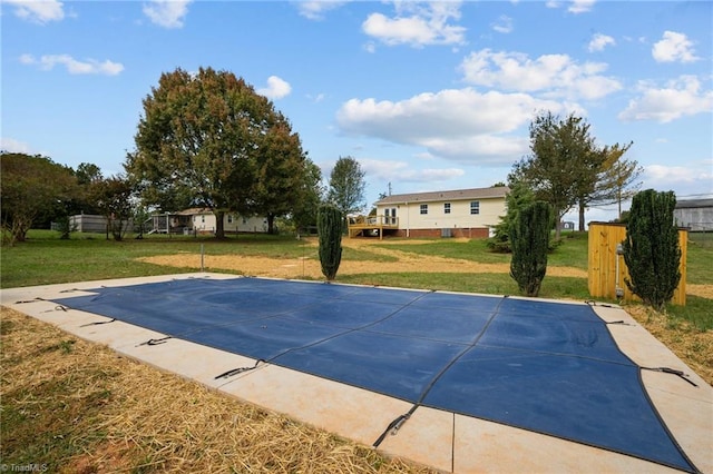 view of swimming pool with a lawn