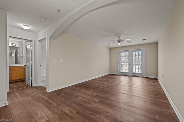 unfurnished room with french doors, ceiling fan, and dark hardwood / wood-style flooring