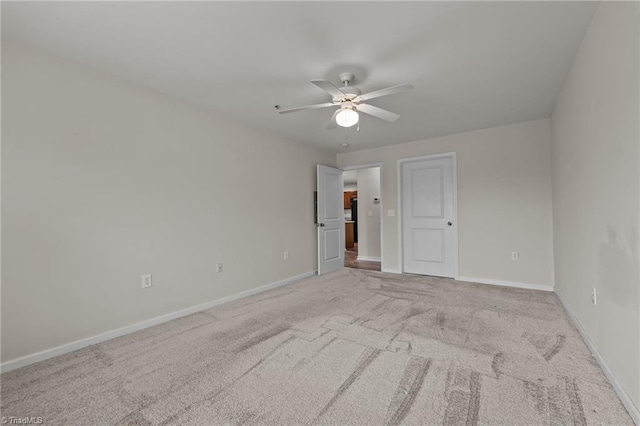 empty room featuring light carpet and ceiling fan