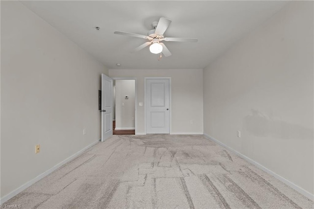 unfurnished room with ceiling fan and light carpet