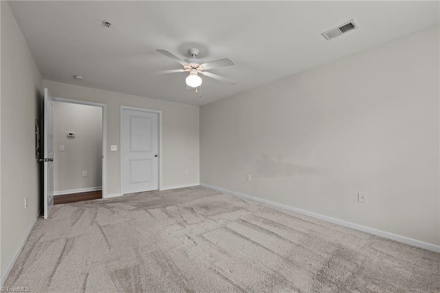 spare room with light colored carpet and ceiling fan