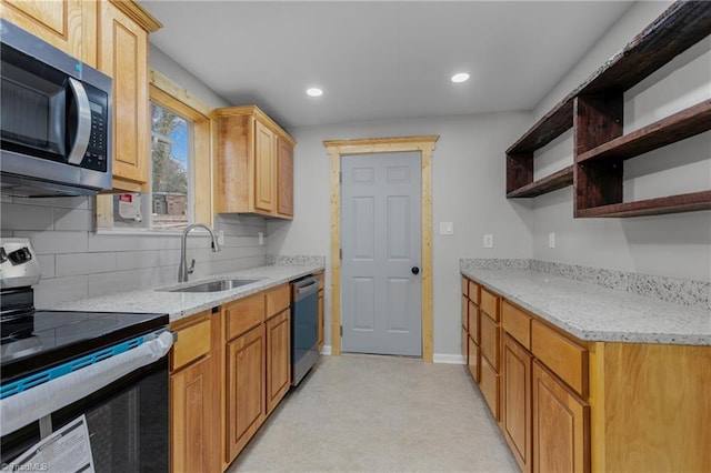 kitchen featuring stainless steel appliances, light stone countertops, sink, and backsplash