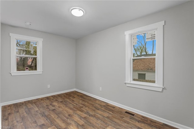 empty room featuring dark hardwood / wood-style flooring