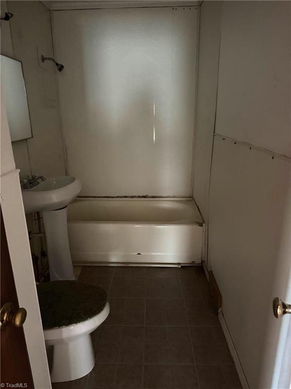 208-210 Long St, Thomasville, NC 27360 - bathroom featuring tile patterned floors,  shower combination, and toilet