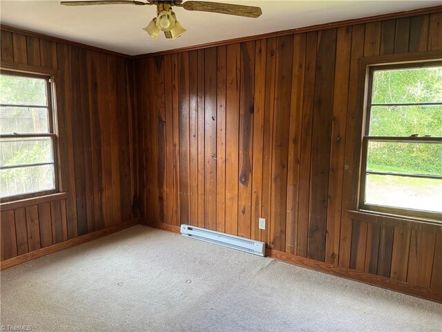 208-210 Long St, Thomasville, NC 27360 - unfurnished room featuring carpet flooring, wood walls, ceiling fan, baseboards, and baseboard heating