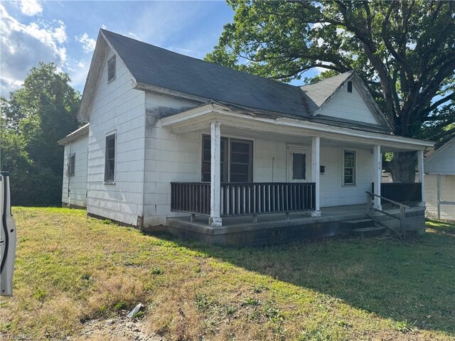 208-210 Long St, Thomasville, NC 27360 - bungalow-style house with a porch, a front yard, and roof with shingles
