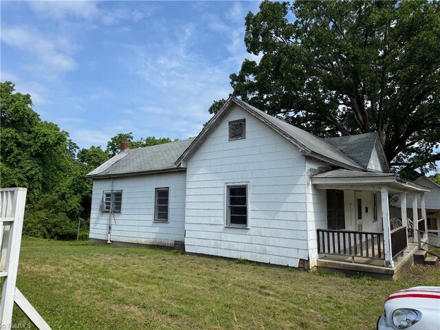 208-210 Long St, Thomasville, NC 27360 - view of side of home with a porch, a lawn, and roof with shingles
