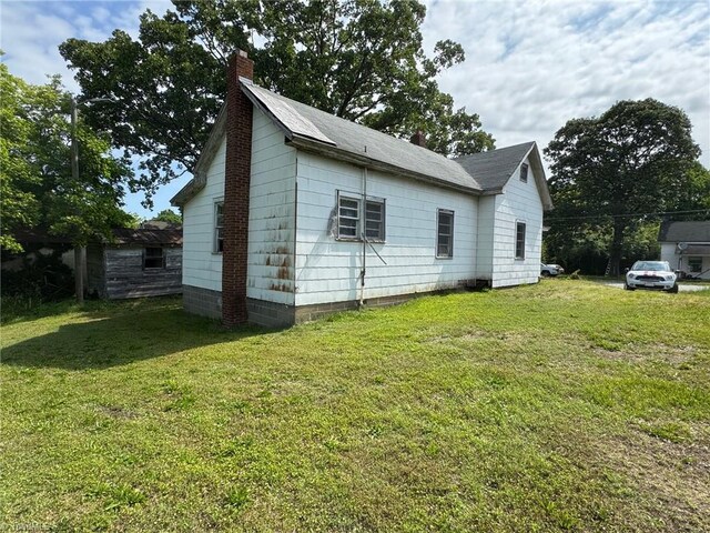 208-210 Long St, Thomasville, NC 27360 - view of home's exterior featuring a chimney and a lawn