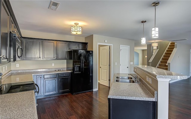 kitchen with dark brown cabinets, sink, black appliances, decorative light fixtures, and dark hardwood / wood-style floors