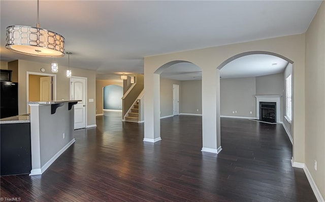 unfurnished living room with dark hardwood / wood-style floors