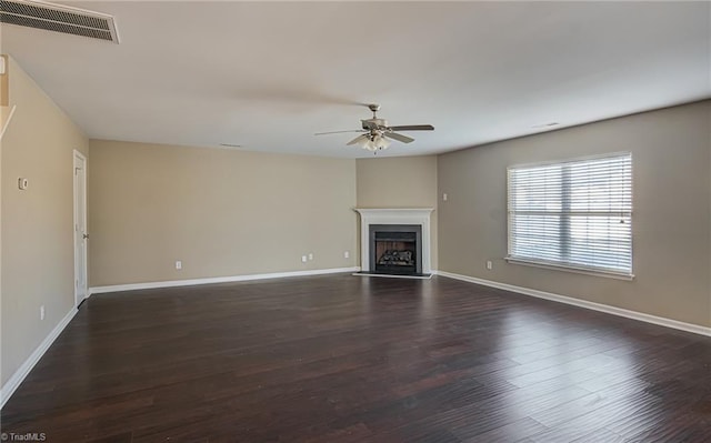 unfurnished living room with ceiling fan and dark wood-type flooring