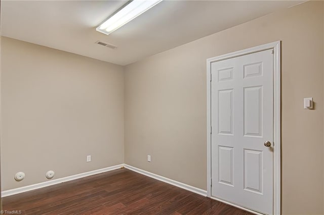 spare room featuring dark wood-type flooring