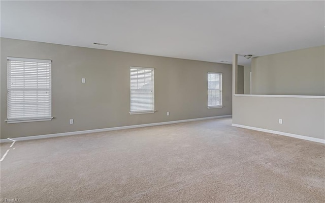 carpeted empty room with plenty of natural light