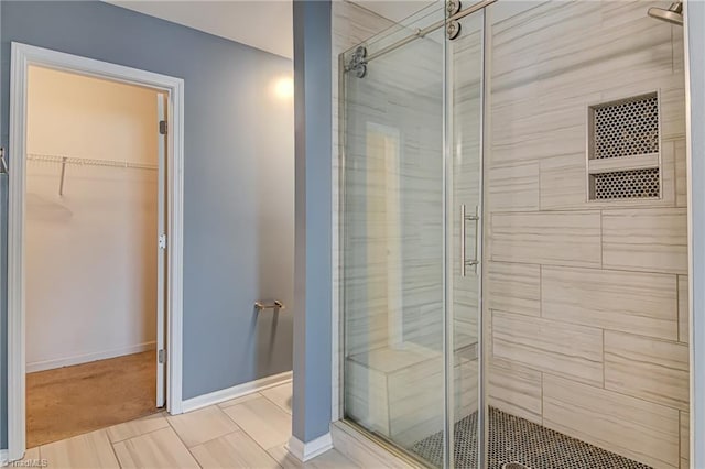 bathroom with a shower with door