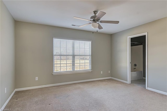 carpeted spare room with ceiling fan