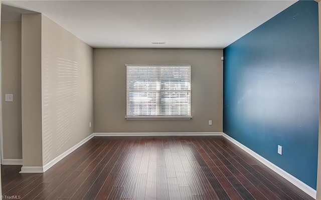 empty room featuring dark hardwood / wood-style flooring