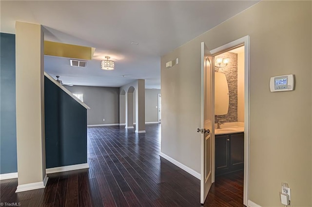 corridor with sink and dark hardwood / wood-style floors