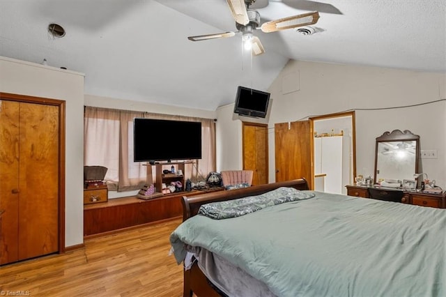 bedroom featuring vaulted ceiling, ceiling fan, and light wood-type flooring