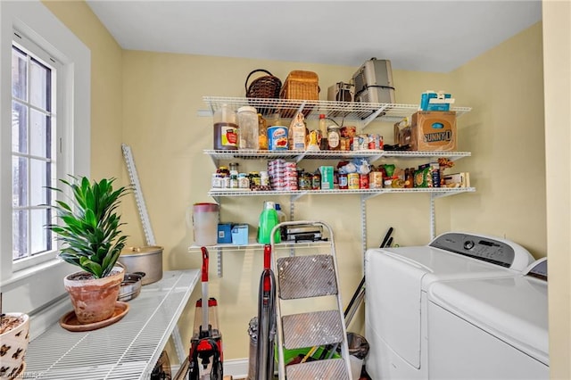 clothes washing area featuring plenty of natural light and washing machine and dryer