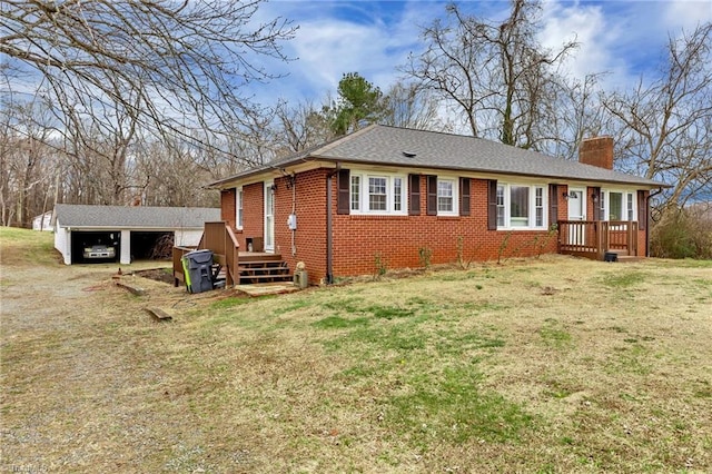 view of front of home with a garage, a carport, and a front yard